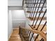 A staircase with hardwood steps, white risers and a decorative wrought iron railing at 3185 Tackett Rd, Douglasville, GA 30135