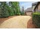 A well manicured backyard area, featuring a mulched lawn, greenery, and brick exterior at 415 Prestwick Ct, Alpharetta, GA 30005