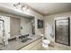 Bathroom with a granite countertop, neutral vanity, framed mirror, and glass shower at 415 Prestwick Ct, Alpharetta, GA 30005