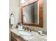 Cozy bathroom featuring granite countertops, a decorative mirror, and a vintage-style faucet at 415 Prestwick Ct, Alpharetta, GA 30005