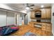 Bedroom with hardwood floors, built-in cabinetry, a ceiling fan, and natural light from the windows at 415 Prestwick Ct, Alpharetta, GA 30005