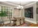 Cozy dining room featuring a decorative chandelier, large windows with views, and hardwood floors at 415 Prestwick Ct, Alpharetta, GA 30005