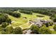 Beautiful aerial view of a well-manicured golf course and clubhouse surrounded by lush trees at 415 Prestwick Ct, Alpharetta, GA 30005