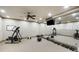 Well-equipped home gym featuring mirrored wall, weights, elliptical, and ceiling fan at 415 Prestwick Ct, Alpharetta, GA 30005