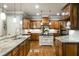 Spacious kitchen featuring custom wood cabinets, granite countertops, kitchen island, and modern pendant lighting at 415 Prestwick Ct, Alpharetta, GA 30005