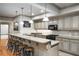 Basement kitchen with granite counters, tile backsplash, a black range, and seating at the bar at 415 Prestwick Ct, Alpharetta, GA 30005