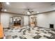 Spacious living room showcases unique tile flooring, neutral walls, and many entryways at 415 Prestwick Ct, Alpharetta, GA 30005