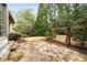 Flagstone patio with a pergola swing in a landscaped backyard at 415 Prestwick Ct, Alpharetta, GA 30005