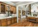 Stylish wet bar featuring custom cabinetry, granite countertops and a wine cooler at 415 Prestwick Ct, Alpharetta, GA 30005