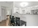 Open kitchen view with counter seating and white cabinets, offering a modern and inviting space at 971 Clover Ln, Lawrenceville, GA 30044