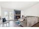 Cozy living room with a stone fireplace, large TV, and French doors to the backyard at 971 Clover Ln, Lawrenceville, GA 30044