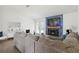 Bright living room featuring a stone fireplace, modern furnishings, and hardwood floors at 971 Clover Ln, Lawrenceville, GA 30044