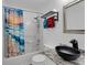 Stylish bathroom with granite countertop, modern black sink, and colorful ocean themed shower curtain at 1020 Adie Cv, Mcdonough, GA 30253