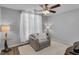 Cozy bedroom with gray walls, carpet, and a comfy chair perfect for relaxation at 1020 Adie Cv, Mcdonough, GA 30253