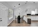 Dining room with vaulted ceiling, modern chandelier and granite countertops, perfect for entertaining guests at 1020 Adie Cv, Mcdonough, GA 30253