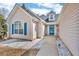 Well-lit front entrance with a blue glass door and decorative stone landscaping at 1020 Adie Cv, Mcdonough, GA 30253