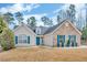 Inviting ranch-style home with a blue front door, stone accents, and well-maintained yard at 1020 Adie Cv, Mcdonough, GA 30253