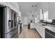 A bright, open kitchen with stainless appliances, eat in area, and modern pendant lighting at 1020 Adie Cv, Mcdonough, GA 30253