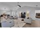 Open-concept living room with wood floors, gray decor, and a view into dining area at 1020 Adie Cv, Mcdonough, GA 30253