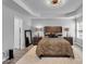 Inviting main bedroom with a tray ceiling, ensuite bathroom, and a plush rug for added comfort at 1020 Adie Cv, Mcdonough, GA 30253