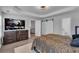 Spacious main bedroom suite featuring a sitting area, TV, and plenty of storage space at 1020 Adie Cv, Mcdonough, GA 30253