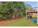 The home includes a backyard with the deck above overlooking the spacious yard and surrounding trees at 1312 Preserve Park Dr, Loganville, GA 30052