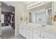 Bathroom with double vanity sink, large mirror, and access to walk-in closet at 1312 Preserve Park Dr, Loganville, GA 30052