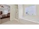 Bathroom with walk in shower, bathtub, window, and view of bedroom at 1312 Preserve Park Dr, Loganville, GA 30052