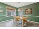 Charming breakfast nook with green walls, wood trim and matching table and chairs at 1312 Preserve Park Dr, Loganville, GA 30052