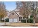 Two-story brick and siding home featuring an attached two-car garage and a covered front porch at 1312 Preserve Park Dr, Loganville, GA 30052