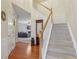 Foyer with hardwood floors, staircase, and views of the living room with fireplace at 1312 Preserve Park Dr, Loganville, GA 30052