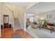Welcoming foyer with hardwood floors, a staircase, and views into the adjacent living spaces at 1312 Preserve Park Dr, Loganville, GA 30052