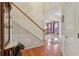 Foyer featuring hardwood floors, staircase, and access to other rooms in the home at 1312 Preserve Park Dr, Loganville, GA 30052