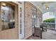 Covered front porch with seating area, brick siding, and an arched glass front door at 1312 Preserve Park Dr, Loganville, GA 30052