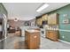 Well-lit eat-in kitchen features an island, light wood cabinets, and stainless steel appliances at 1312 Preserve Park Dr, Loganville, GA 30052