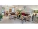 Bright living room featuring neutral carpet, comfortable sofas, and a glass coffee table leading into the dining room at 1312 Preserve Park Dr, Loganville, GA 30052