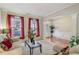 Cozy living room with two sofas, large windows with red drapes and detailed white door trim at 1312 Preserve Park Dr, Loganville, GA 30052