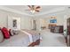Large main bedroom boasts an attached sitting area and a tray ceiling at 1312 Preserve Park Dr, Loganville, GA 30052