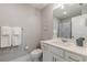 Clean bathroom with a white vanity, sink, and a well-lit mirror, with a view of the toilet at 1703 Prospect Way, Conyers, GA 30094