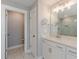 Bright bathroom featuring marble floors and white cabinets and countertops at 1703 Prospect Way, Conyers, GA 30094