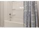 This bathroom features a neutral shower and a blue patterned shower curtain at 1703 Prospect Way, Conyers, GA 30094