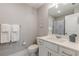 Bright bathroom with a white vanity, framed mirror, and decorative artwork at 1703 Prospect Way, Conyers, GA 30094