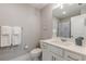This bathroom features neutral walls and floors, a single sink vanity, a mirror, and a toilet at 1703 Prospect Way, Conyers, GA 30094