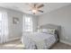 Cozy bedroom with a tufted headboard, patterned bedding, and bright natural light from the windows at 1703 Prospect Way, Conyers, GA 30094