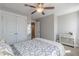 A bedroom features neutral walls, a ceiling fan, a closet, and a dresser at 1703 Prospect Way, Conyers, GA 30094