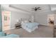 Spacious bedroom featuring a tray ceiling, ceiling fan, and sitting area at 1703 Prospect Way, Conyers, GA 30094