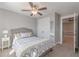Bedroom featuring neutral walls, carpet floors, a ceiling fan, closet and access to another room at 1703 Prospect Way, Conyers, GA 30094