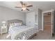 A bedroom features neutral walls, a ceiling fan, closet, and access to another room at 1703 Prospect Way, Conyers, GA 30094