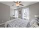 Serene bedroom featuring light gray walls, white trim, and abundant natural light from two windows at 1703 Prospect Way, Conyers, GA 30094