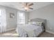 Sunlit bedroom with neutral walls, white trim, ceiling fan, and a decorative floral picture at 1703 Prospect Way, Conyers, GA 30094